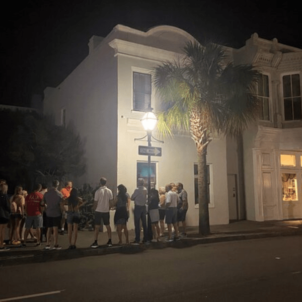 a group of people walking down a street in front of a building