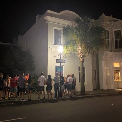 a group of people walking down a street in front of a building